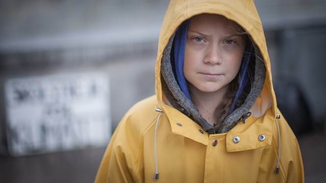 Greta Thunberg in a yellow coat.