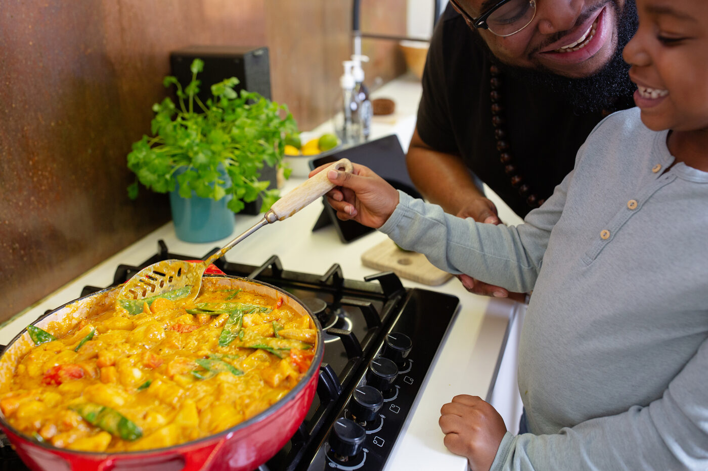 A father and son cook an eco-friendly vegetarian curry together.