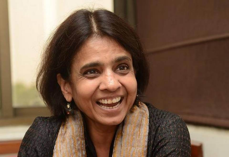 Sunita Narain smiling whilst seated indoors near a window.
