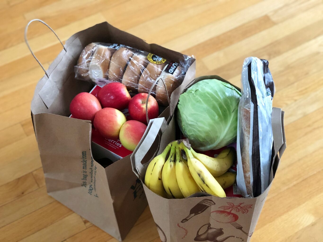 Two paper food shopping delivery bags for eco-friendly living.